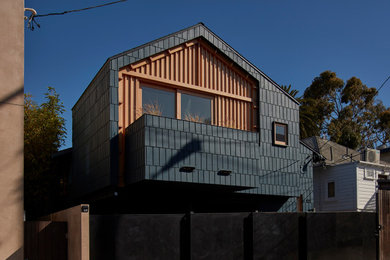 Photo of a medium sized and blue contemporary two floor detached house in Los Angeles with wood cladding, a half-hip roof, a shingle roof, a grey roof and shingles.