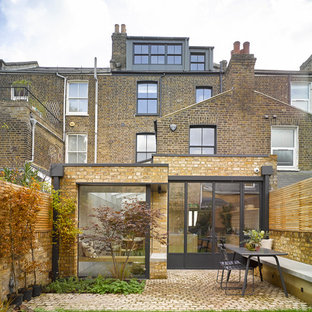 Contemporary brick house exterior in London with three floors.