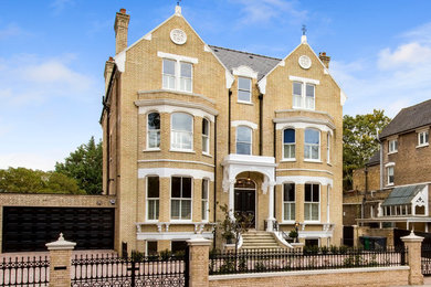 Inspiration for a large traditional house exterior in London with three floors.