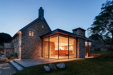 Design ideas for a large rural house exterior in Devon with stone cladding.