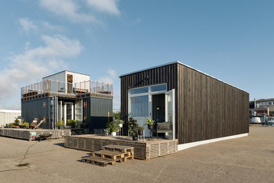 This is an example of an industrial bungalow house exterior in Copenhagen with metal cladding and a flat roof.