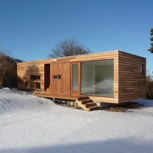 Photo of a small and brown scandi one floor house exterior in Copenhagen with wood cladding and a flat roof.
