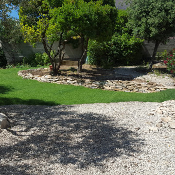 Aménagement extérieur avec muret en pierres sèches et pelouse en plaques