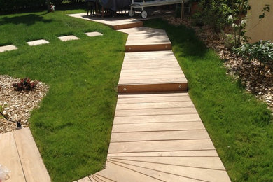Photo of a small contemporary front full sun garden for spring in Other with a garden path and decking.