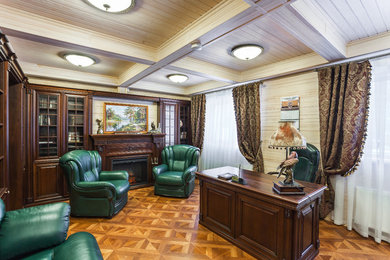 Study room - mid-sized traditional freestanding desk medium tone wood floor and brown floor study room idea in Saint Petersburg with beige walls, a standard fireplace and a wood fireplace surround