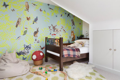 Inspiration for a small eclectic gender neutral toddler’s room in London with carpet and green walls.