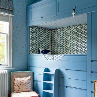Photo of a classic gender neutral children’s room in London with blue walls, carpet and beige floors.