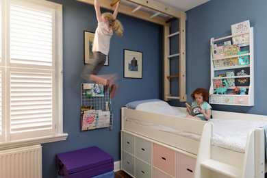 This is an example of a traditional children’s room for girls in London with blue walls.