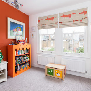 Design ideas for a classic gender neutral playroom in London with orange walls, carpet and grey floors.