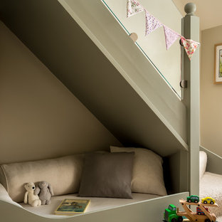 This is an example of a small farmhouse gender neutral playroom in Gloucestershire with carpet, beige floors and beige walls.