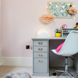 Design ideas for a traditional kids' study space for girls in Other with pink walls, carpet and beige floors.
