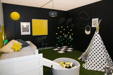 Design ideas for a medium sized eclectic gender neutral kids' bedroom in London with black walls and green floors.