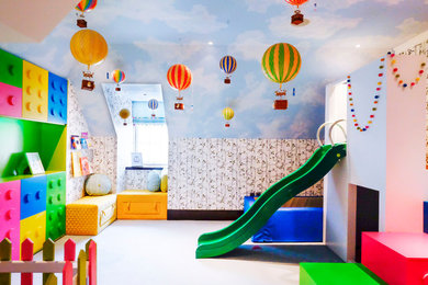 Inspiration for a large modern gender neutral kids' bedroom in London with yellow walls, carpet and blue floors.