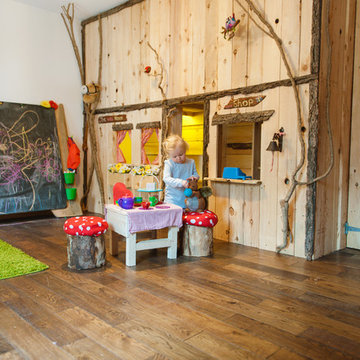 Indoor forest cottage playroom with giant blackboard and rustic storage