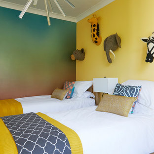 Eclectic gender neutral children’s room in London with yellow walls.