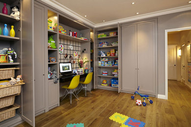 This is an example of a classic gender neutral kids' bedroom in London with medium hardwood flooring and grey walls.