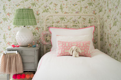 This is an example of a traditional children’s room for girls in London with carpet and grey floors.