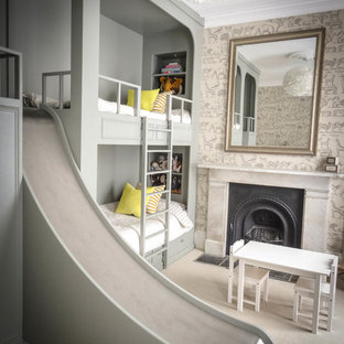 This is an example of a large classic gender neutral children’s room in London with grey walls, carpet and beige floors.