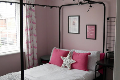 Medium sized contemporary children’s room for girls in West Midlands with pink walls, carpet and grey floors.