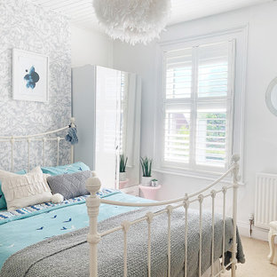 Medium sized classic teen’s room for girls in Gloucestershire with white walls, carpet, beige floors and wallpapered walls.