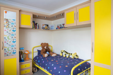 Inspiration for a traditional gender neutral children’s room in Other with white walls.
