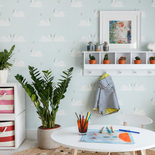 Inspiration for a contemporary gender neutral kids' bedroom in London with multi-coloured walls, carpet and grey floors.