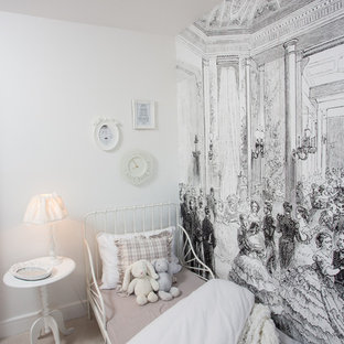 Inspiration for a shabby-chic style children’s room for girls in Manchester with carpet, white walls and beige floors.