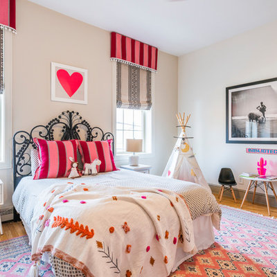 Example of a large transitional girl medium tone wood floor and brown floor kids' room design in Philadelphia with beige walls