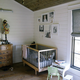Kids' room - country girl medium tone wood floor kids' room idea in Nashville with white walls