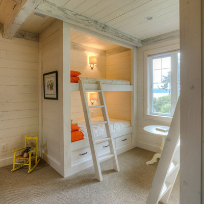 Example of a classic gender-neutral carpeted kids' room design in Seattle with beige walls