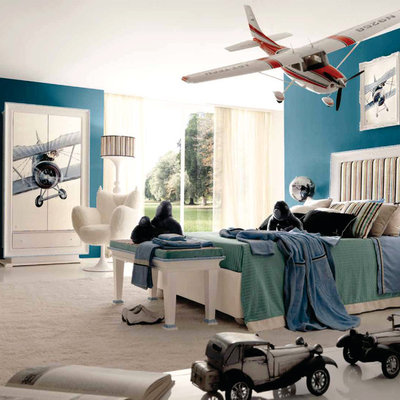 Kids' room - large modern boy carpeted kids' room idea in London with blue walls