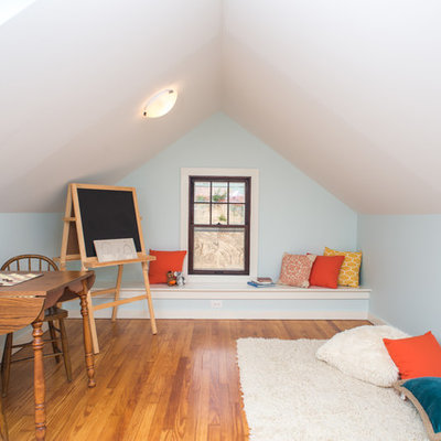 Example of a classic gender-neutral medium tone wood floor kids' room design in Detroit with blue walls