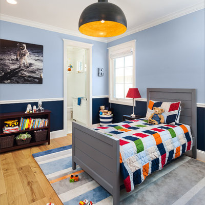 Example of a classic boy light wood floor and beige floor kids' room design in Phoenix with blue walls