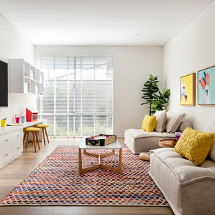 Inspiration for a contemporary gender-neutral kids' playroom for kids 4-10 years old in Perth with white walls, medium hardwood floors and brown floor.