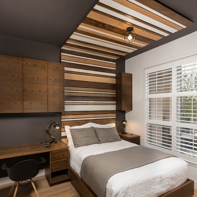 Mid-sized minimalist boy medium tone wood floor and brown floor kids' room photo in Toronto with multicolored walls