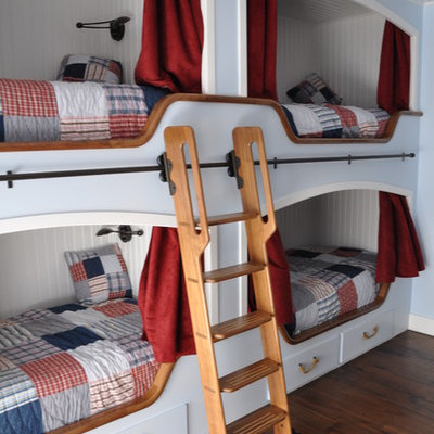 Example of a large classic gender-neutral dark wood floor and brown floor kids' room design in Los Angeles with white walls
