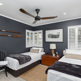 Photo of a beach style kids' bedroom in Sunshine Coast with blue walls and grey floor.