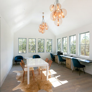 Example of a country gender-neutral light wood floor and brown floor kids' study room design in Charleston with white walls