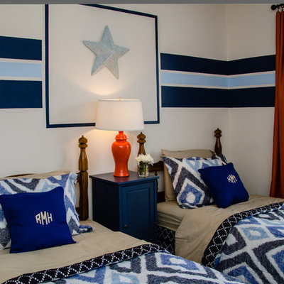 Trendy gender-neutral kids' room photo in Charlotte with multicolored walls