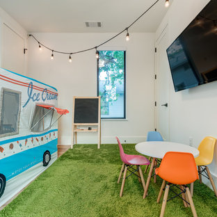 Trendy gender-neutral kids' room photo in Austin with beige walls