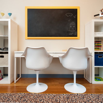 Inspiration for a mid-sized transitional boy medium tone wood floor kids' room remodel in New York with beige walls