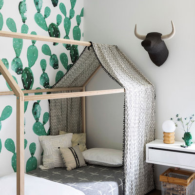 Inspiration for a mid-sized contemporary medium tone wood floor kids' room remodel in New York with gray walls