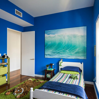 Example of a trendy boy dark wood floor kids' bedroom design in New York with blue walls