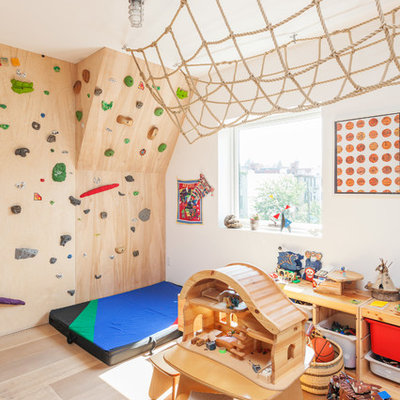 Inspiration for a contemporary gender-neutral light wood floor kids' room remodel in New York with white walls