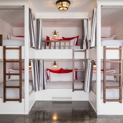Example of a large beach style gender-neutral concrete floor and gray floor kids' room design in Minneapolis with white walls