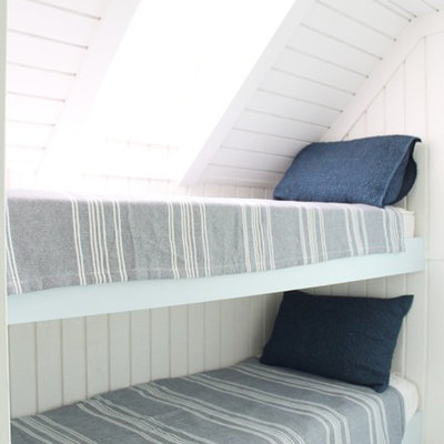 Example of a beach style gender-neutral kids' bedroom design in Miami with white walls