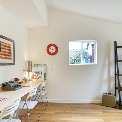 Inspiration for a transitional gender-neutral light wood floor kids' room remodel in Seattle with white walls