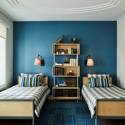 Example of a trendy boy medium tone wood floor kids' room design in New York with blue walls