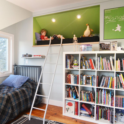 Example of a mid-sized trendy boy medium tone wood floor kids' room design in Austin with blue walls