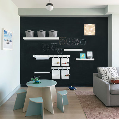 Example of a large trendy light wood floor and beige floor kids' room design in New York with blue walls